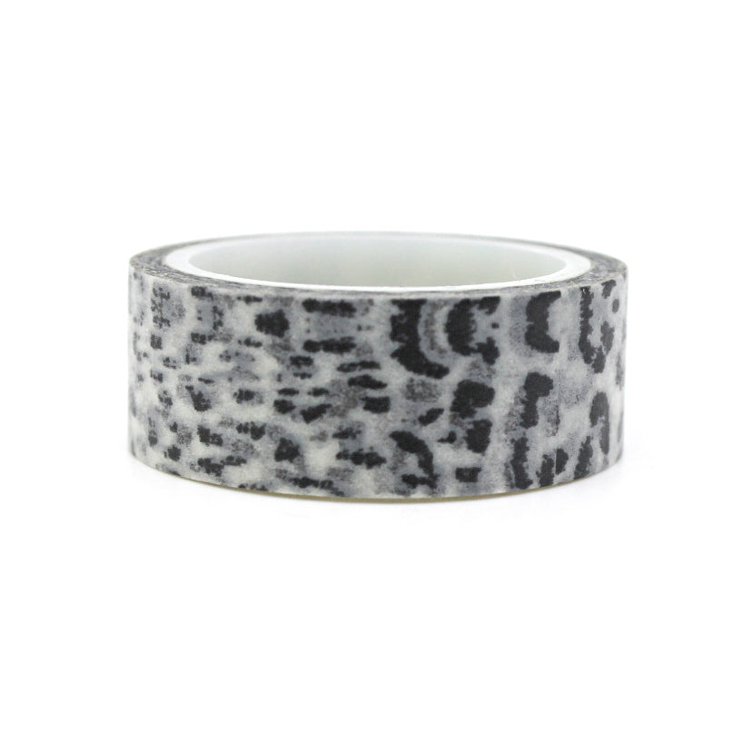 A close-up photo of snow leopard pattern washi tape. The tape features a white background with intricate black spots resembling the distinctive markings of a snow leopard. The pattern exudes elegance and captures the beauty of this majestic big cat. This tape is sold exclusively at BBB Supplies Craft Shop.