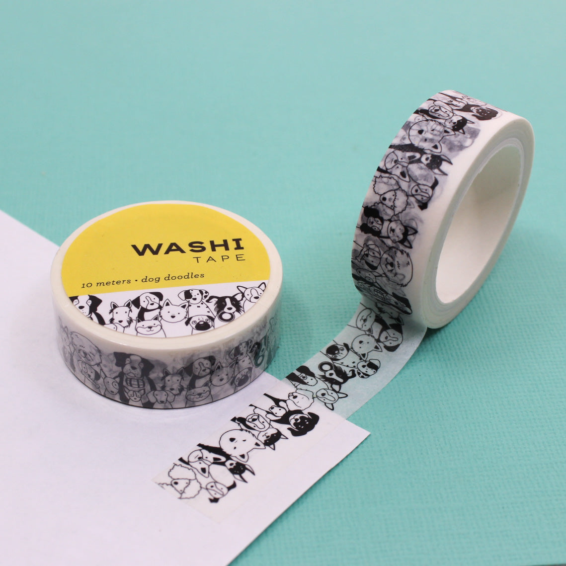 Black & White Dog Doodles Washi Tape featuring fun hand-drawn dog illustrations in black on a white background, ideal for decorating planners, scrapbooks, and gifts with a playful canine theme.