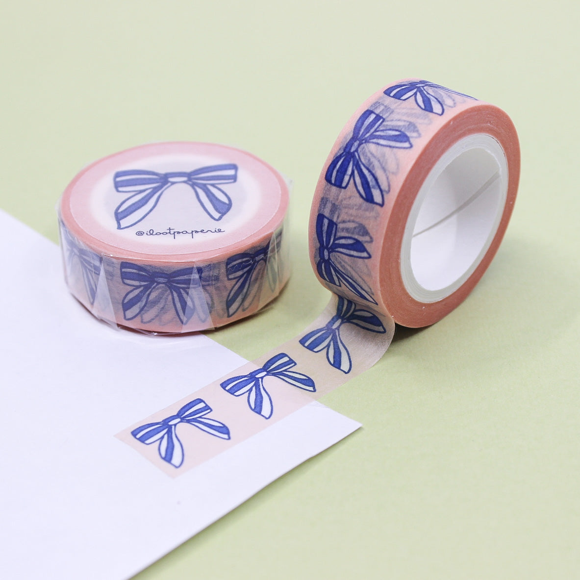 "Blue Bows & Ribbons Washi Tape" features a charming design of blue bows and ribbons, adding a touch of elegance and whimsy to your crafts, journals, and gift wrapping.