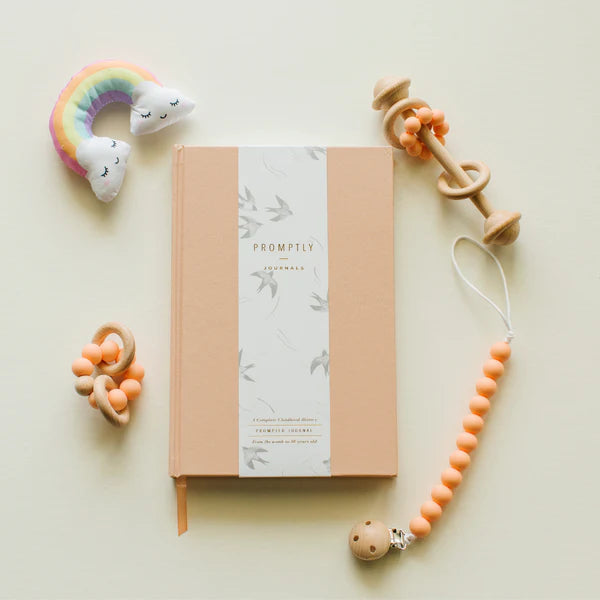 This peach color childhood history journal has prompts to help parents write their child's story in each phase as a keepsake. This journal is from promptly and sold at BBB Supplies Craft Shop.