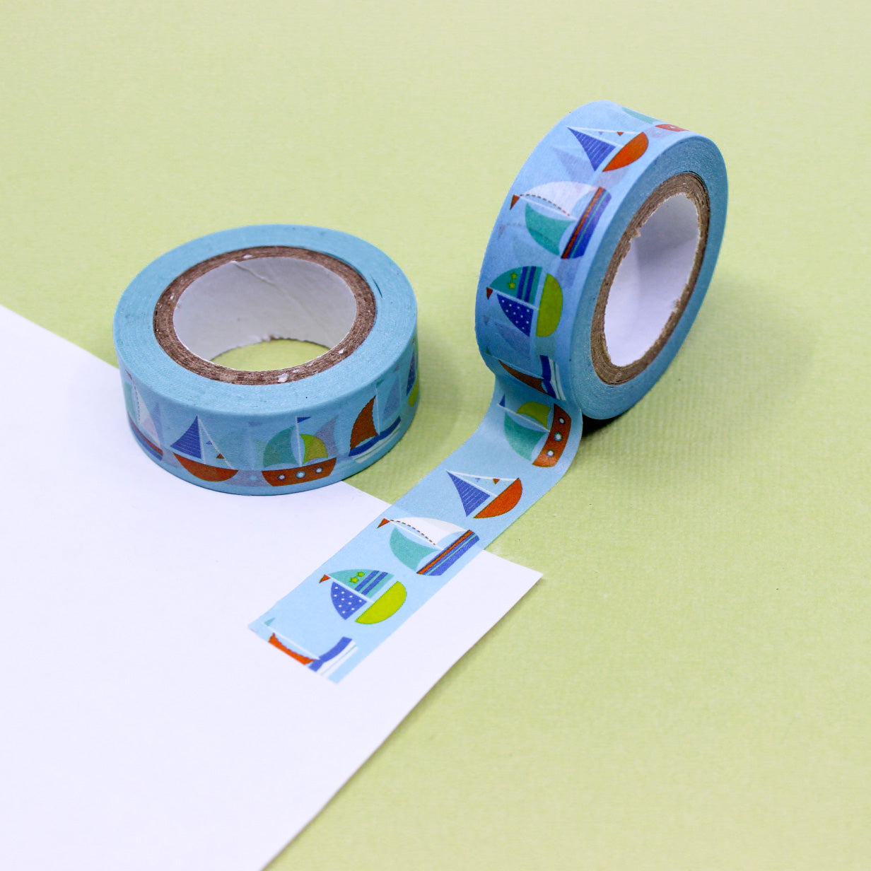 Blue washi tape with small sailboat illustrations on a light blue background, perfect for nautical-themed crafts and decorations.