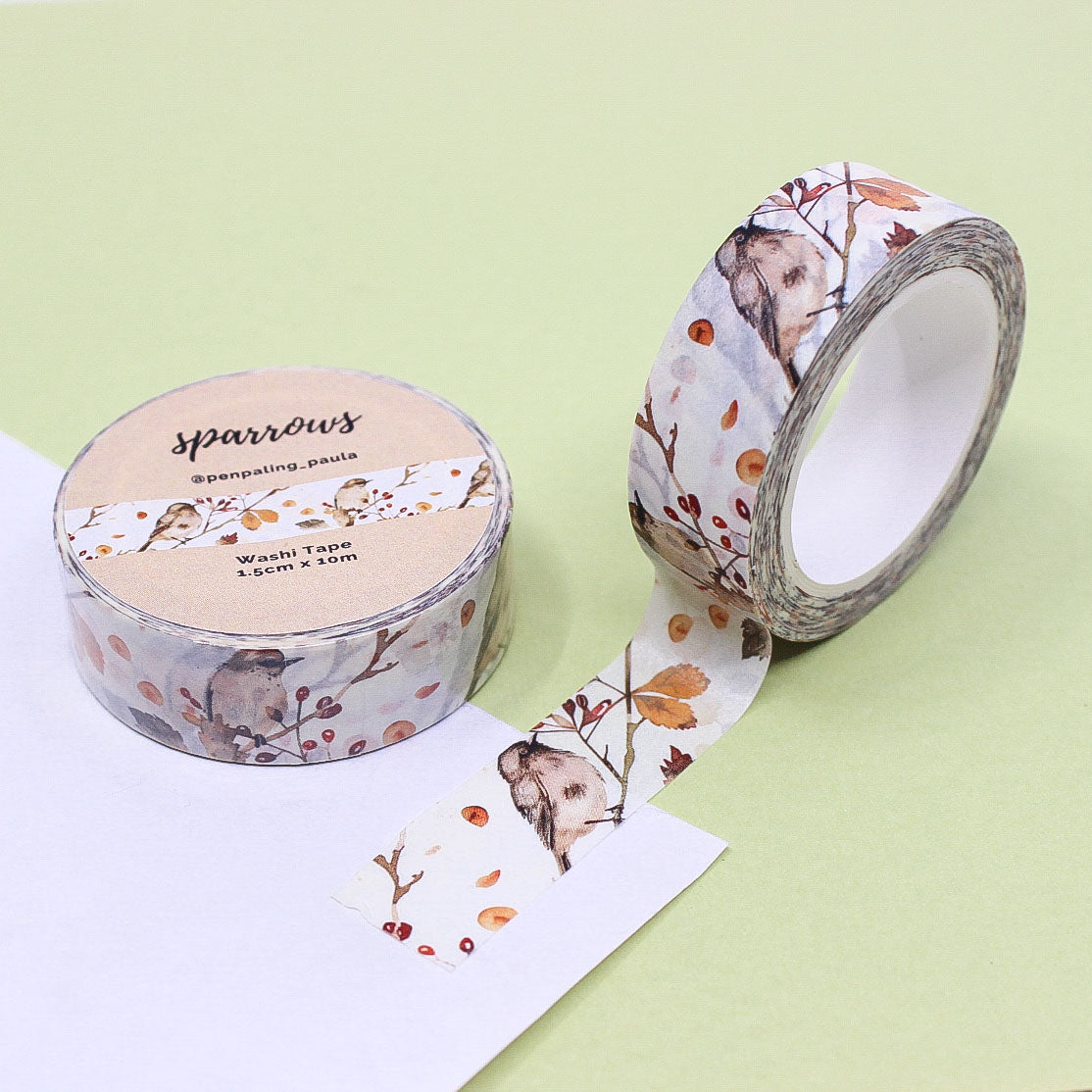 Washi tape featuring sparrows perched on autumn branches with vibrant fall leaves in shades of orange, red, and gold.