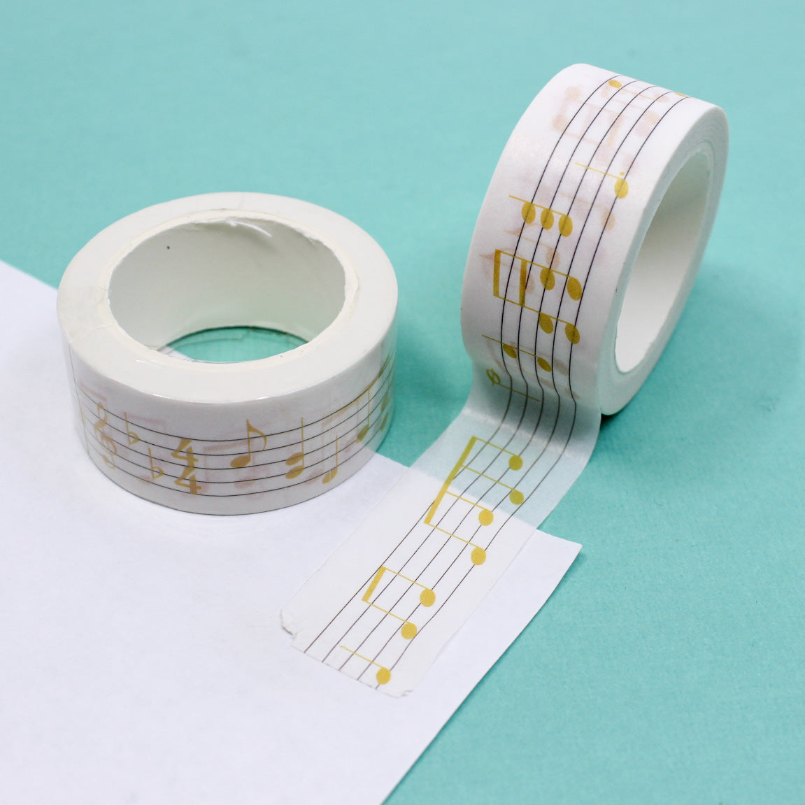 Add a musical flair to your projects with this wide washi tape featuring yellow music notes. Perfect for music enthusiasts or anyone looking to add a playful touch to their crafts. This tape is sold at BBB Supplies Craft Shop.