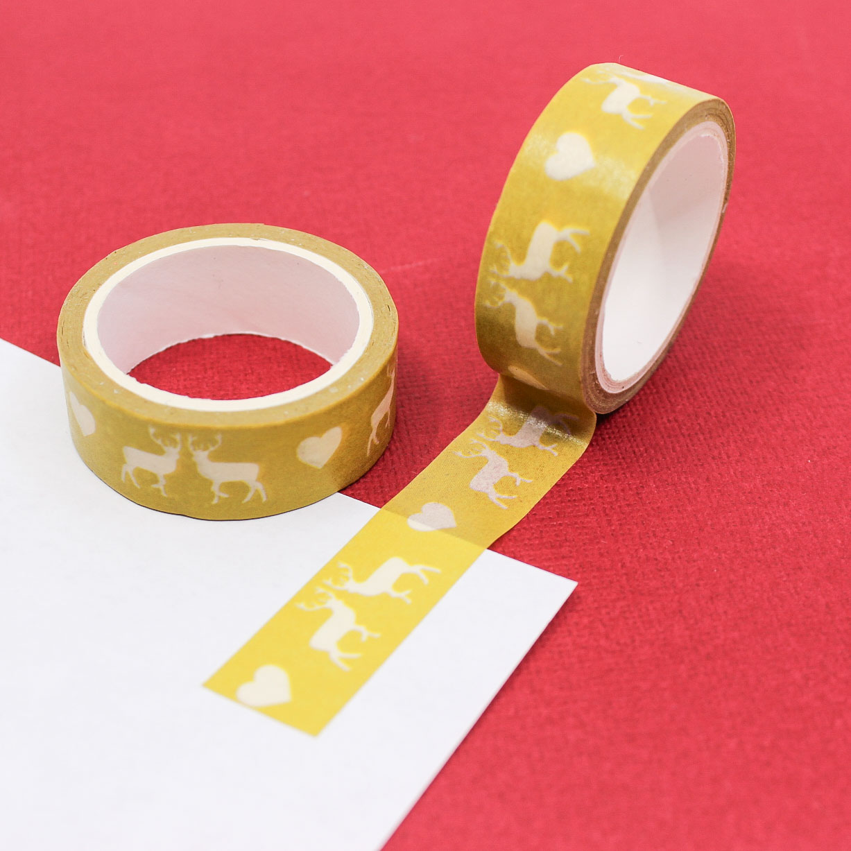 Yellow washi tape featuring cute deer and heart illustrations on a bright yellow background, ideal for scrapbooking and crafting.